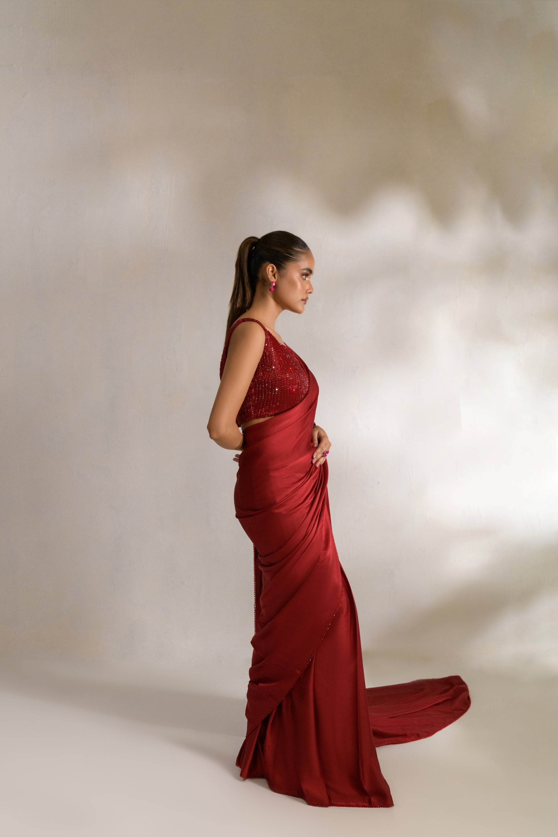 Pre-draped saree silhouette with structured pleats for body contouring
