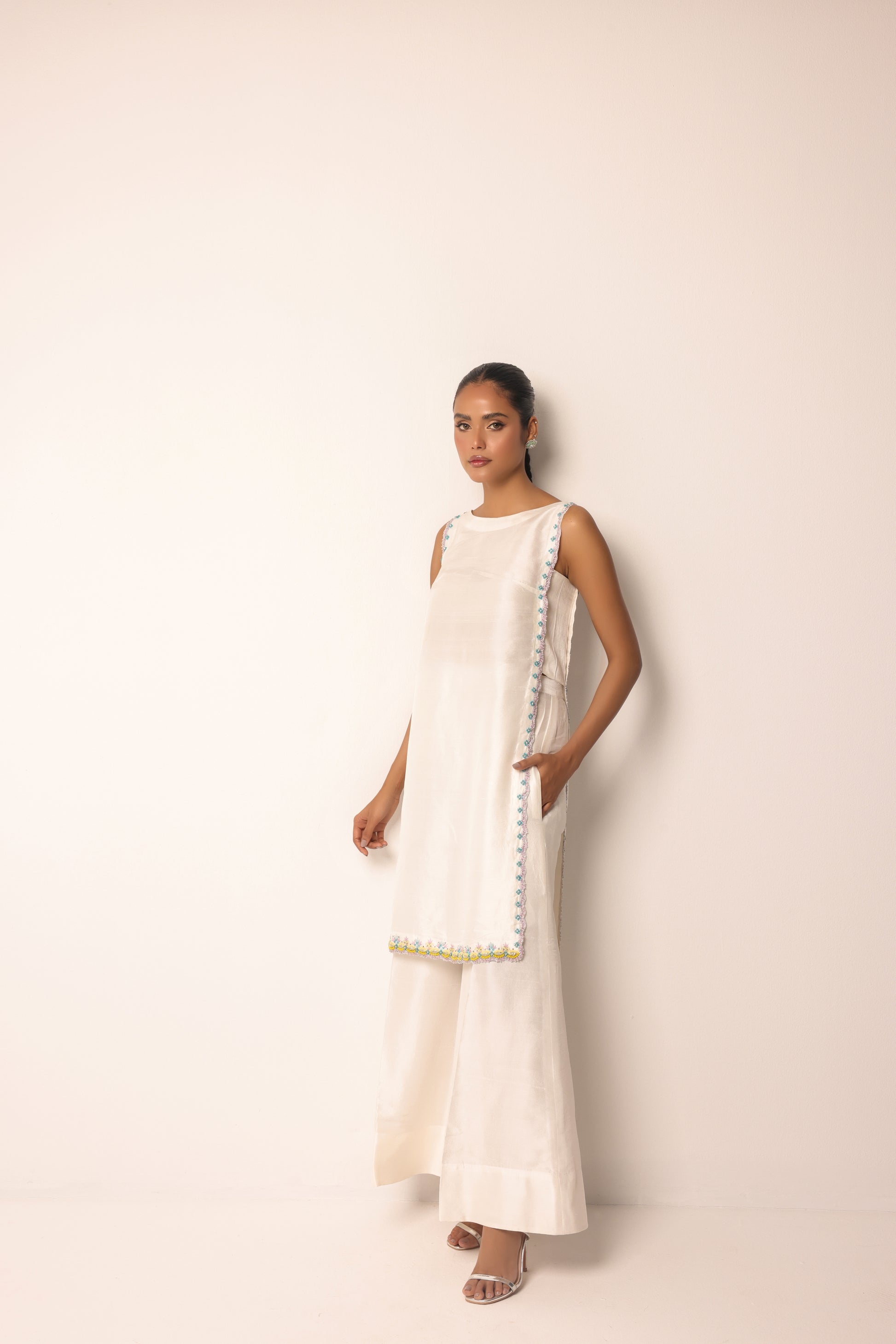 Contemporary structured sleeveless tunic with asymmetrical panel for a modern look