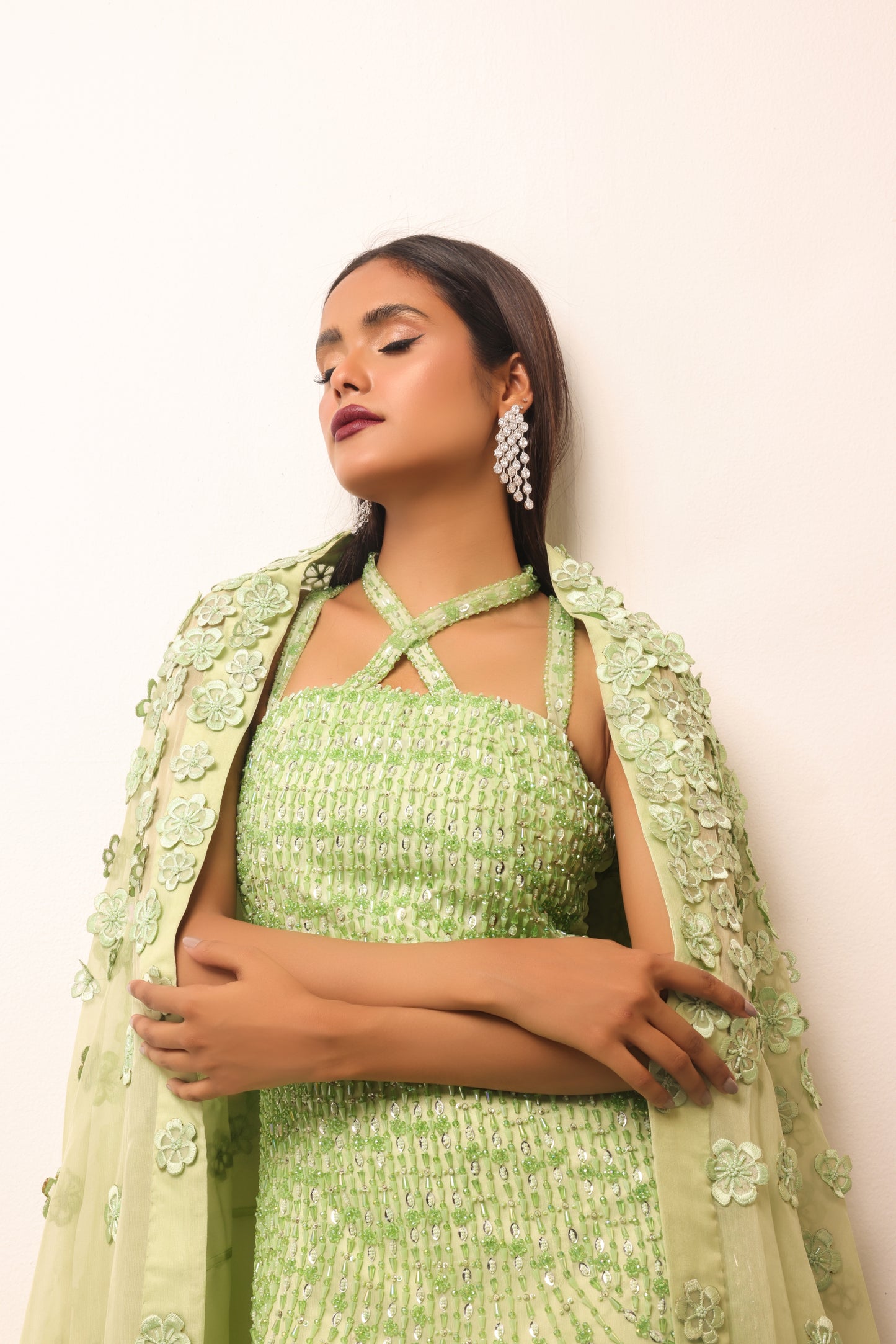 Handcrafted gown featuring intricate beadwork and floral details
