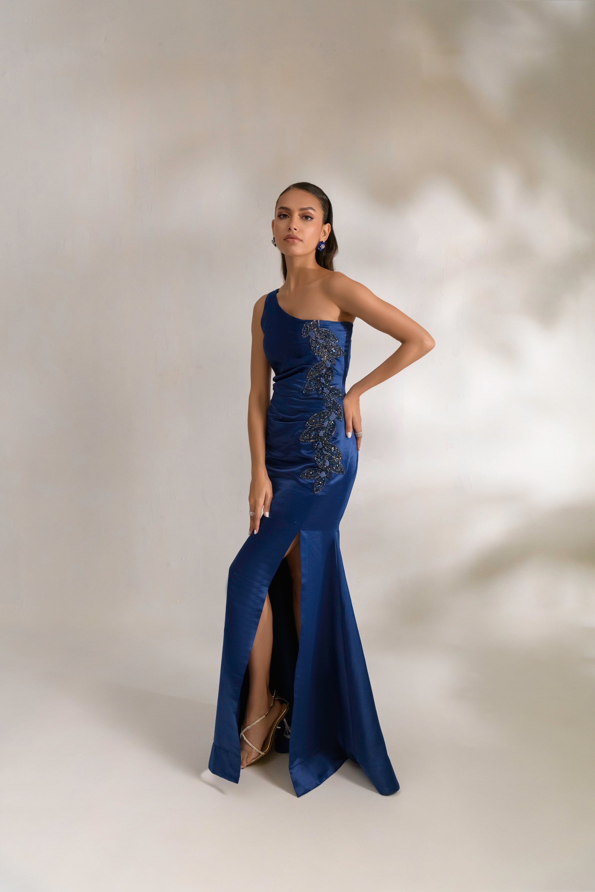 Draped waist detailing and thigh-high slit for added allure
