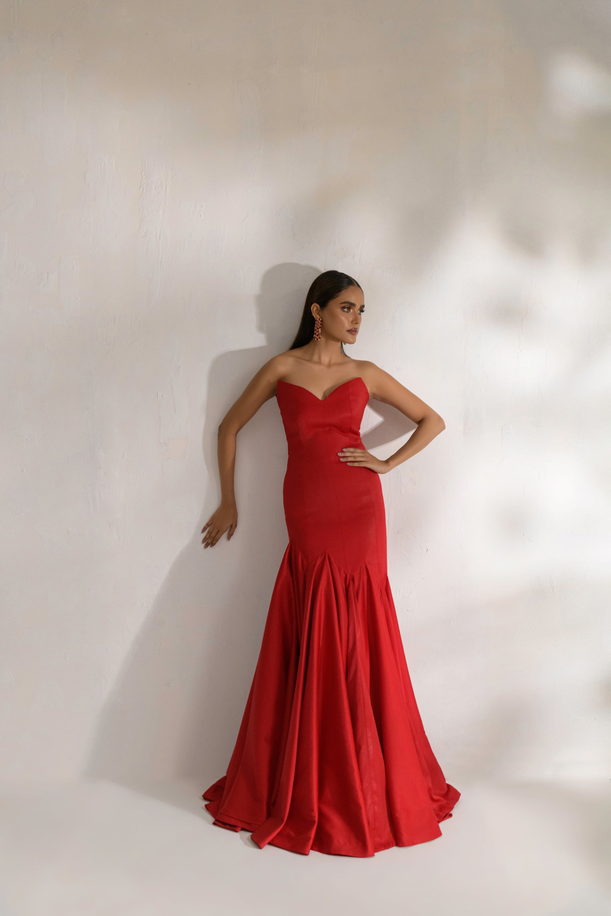 Ruby gown with hand-embellished crystal shoulder cape for red carpet glamour