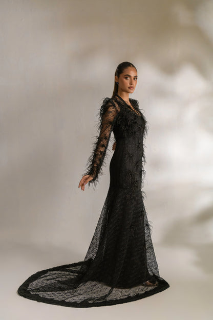 Bodycon floor-length gown with sheer lace detailing and feather embellishment